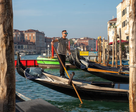 October 31, 2022 - Venice, Italy: Gondolier standing in a gondola. Tourism concept.の写真素材