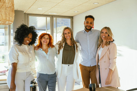 Multiethnic business team smiling while standing together in the office. Business concept.