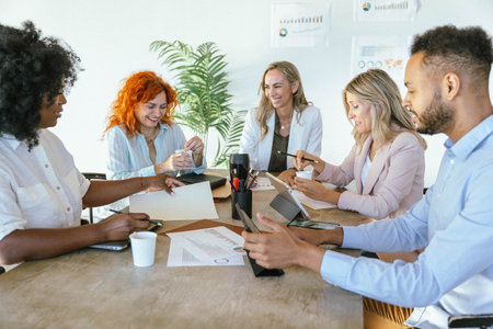 Diverse business people smiling while having a meeting for planning and strategy discussion. Business and brainstorming concept.の写真素材