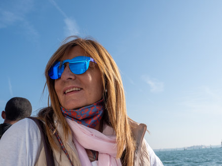 Woman with sunglasses enjoying a boat ride on her vacations. Tourism concept.の写真素材
