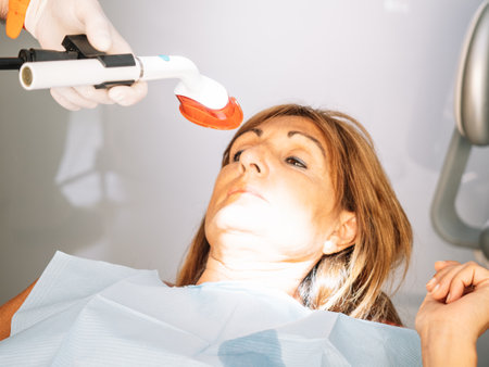 Caucasian Patient Goes To Dentist's Office For Teeth Whiteningの写真素材
