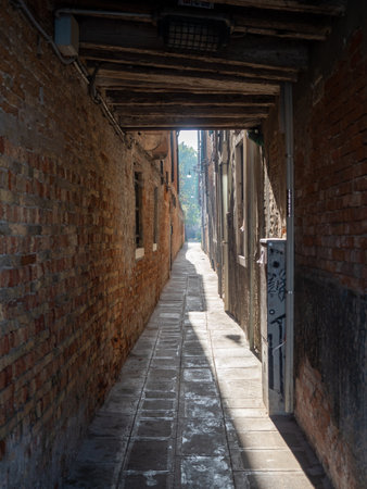 View of a narrow street in the city of Venice, Italy. Tourism concept.の写真素材