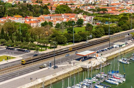 Suburban train passing by a street of Lisbon - Portugalのeditorial素材