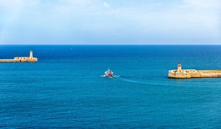 Boat leaving the port of Valletta - Maltaの写真素材