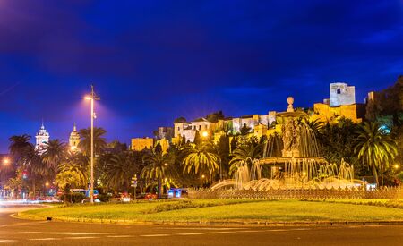 Tres Gracias Fountain and Alcazaba Castle in Malaga - Adalusia, Spainの写真素材