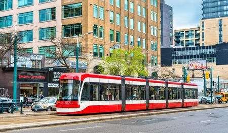 Modern streetcar on a street of Toronto. The Toronto streetcar system is the largest and the busiest light-rail system in North Americaのeditorial素材