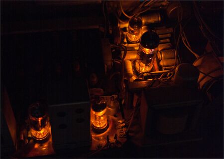 Vacuum tubes glowing in a vintage radio-gramophoneの写真素材