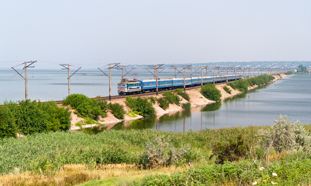 Passenger electric train passes the Dnieper river (Kahovs'ke reservoir or "sea") on the way to the Southの写真素材