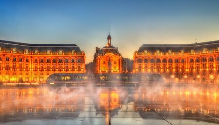 Iconic view of Place de la Bourse with tram and water mirror fountain in Bordeaux - France, Girondeの写真素材