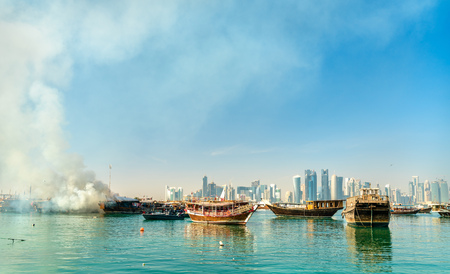 Traditional arabic dhow on fire in Doha, Qatarの写真素材