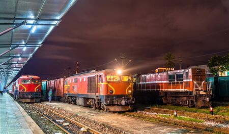 Locomotives with a passenger and a freight trains at Da Nang station in Vietnam