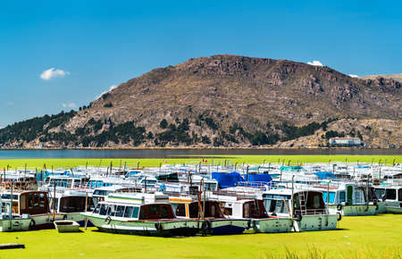 Boats docked at Puno on Lake Titicaca in Peruの写真素材