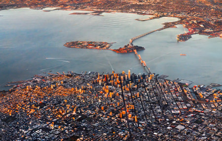 Aerial view of San Francisco Downtown with the San Francisco - Oakland Bay Bridge at sunset. California, United Statesの写真素材