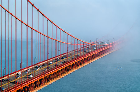 Golden Gate Bridge Shrouded in Mystical Fog Overlooking the Bay in San Francisco - California, United Statesの写真素材