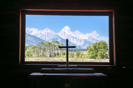 Grand Tetons with a wooden cross from the Chapel of the Transfiguration in Grand Teton National Park, Wyoming, United Statesの写真素材