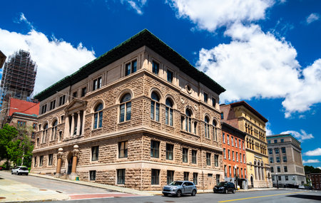 Renaissance Revival Albany Masonic Temple built in 1896 in Albany, United States, shows massive rusticated stone walls, arched windows, and green copper cornice under a vivid blue summer skyの写真素材