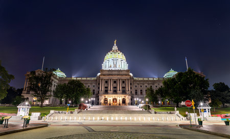 The Pennsylvania State Capitol in Harrisburg, Pennsylvania, USA. The historic Beaux-Arts building is viewed from its grand main entrance on a clear nightの写真素材