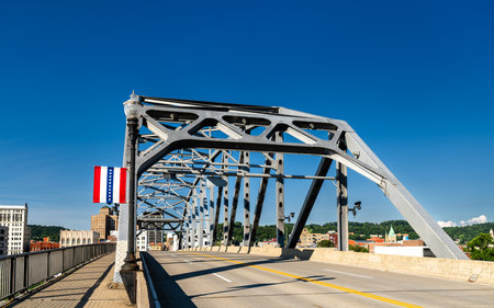 The South Side Bridge, a cantilever truss structure, crossing the Kanawha River in Charleston, West Virginia, USA. A flag of the city is on displayの写真素材