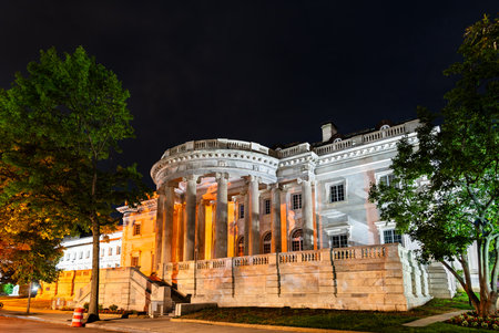 Nighttime view of Memorial Continental Hall in Washington, D.C., United States, featuring its neoclassical facade and grand columns lit under dramatic lightingの写真素材