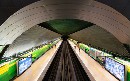 Santiago, Chile - October 16, 2025: View of the platform and tracks at Barrancas Metro Station. Commuters wait at the underground station which features a curved ceiling and green wallsのeditorial素材