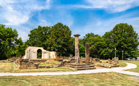 Old Alabama State Capitol ruins in Tuscaloosa. Historic site features stone columns and foundation remains in Capitol Park under a blue skyの写真素材
