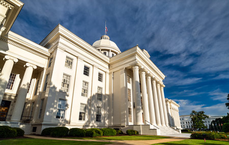 Alabama State Capitol in Montgomery, United States. Greek Revival architecture features a white portico and columns under a blue skyの写真素材