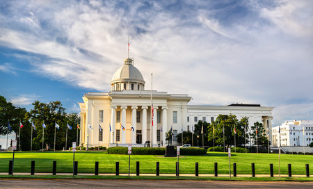 A beautiful sunset view of the white Alabama State Capitol building with its iconic dome and columns under a blue sky in Montgomery.の写真素材