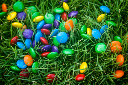 small bright colored candies in grass.の写真素材