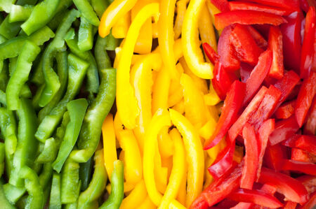 sliced colourful paprika peppers background.の写真素材