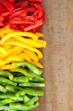 sliced colourful paprika peppers background.の写真素材