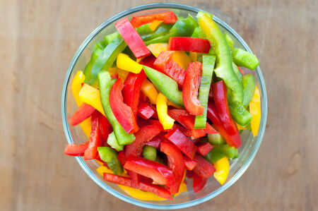 Colored peppers mixed in a glass bowlの写真素材