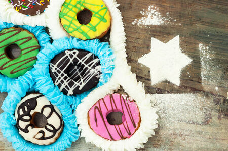 bright donuts on wooden background.の写真素材
