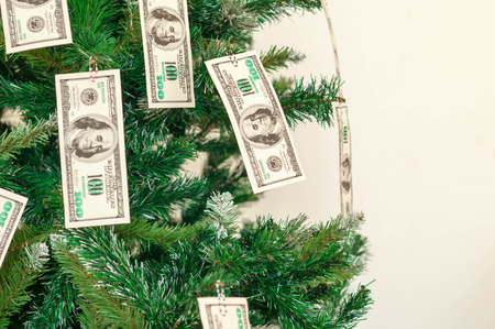 Christmas tree decorated with dollars notes.の写真素材
