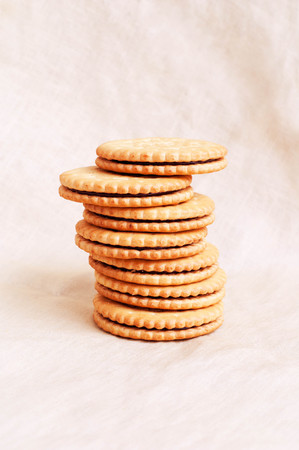 Sweet crispy yellow biscuits on textile background