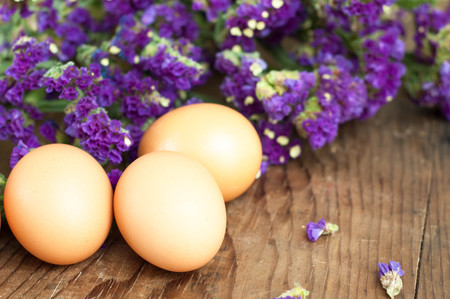 fresh white eggs with flowers.の写真素材