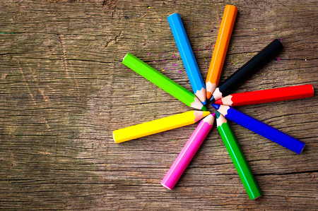 Bright pencils of different colors  on wooden backgroundの写真素材