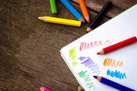Bright pencils of different colors  on wooden backgroundの写真素材