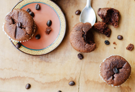 chocolate cupcakes with coffee beans on brown plateの写真素材