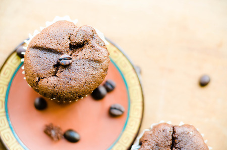 chocolate cupcakes with coffee beans on brown plateの写真素材