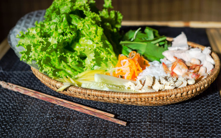 straw plate with ingredients for vietnamese spring rolls.の写真素材