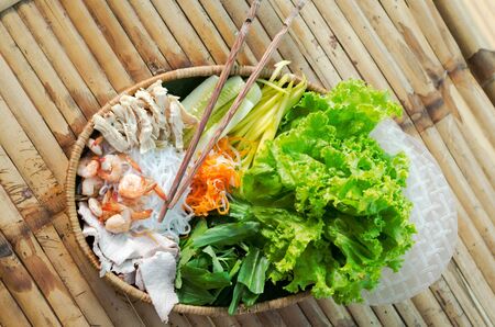 straw plate with ingredients for vietnamese spring rolls.の写真素材
