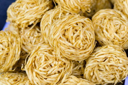 yellow pasta nests on asian market place.