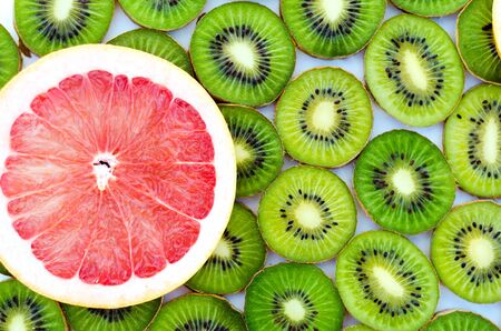 Bright background with kiwi fruit, grapefruit and oranges.