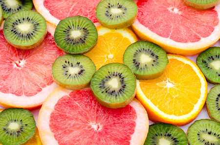 Bright background with kiwi fruit, grapefruit and oranges.の写真素材