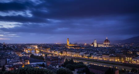 View of Florence during sunset showing the River Arno, Ponte Vecchio, the Palazzo Vecchio and the Duomo - Florence, Tuscany, Italy - 24th May 2016の写真素材