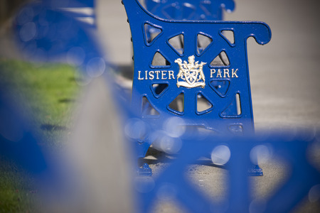 Lister Park bench with Bradford Council crest and insignia outside Cartwright Hall Museum and Art Galleryのeditorial素材