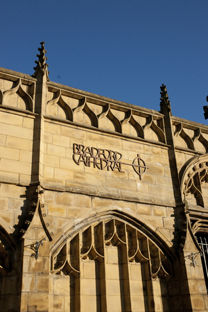 View of Bradford Cathedral logo and sign on Forster Square steps entrance against blue sky. September, 2013のeditorial素材