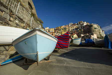 A view of fishing boats on the jetty in the historic Cinque Terre village Manarola in La Spezia, Liguria, Italy - 16th May 2016の写真素材
