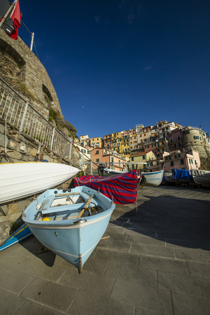 A view of fishing boats on the jetty in the historic Cinque Terre village Manarola in La Spezia, Liguria, Italy - 16th May 2016のeditorial素材