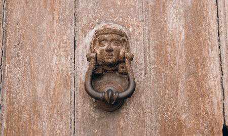 Old Rustic Door Knocker on an old Wooden Doorの写真素材